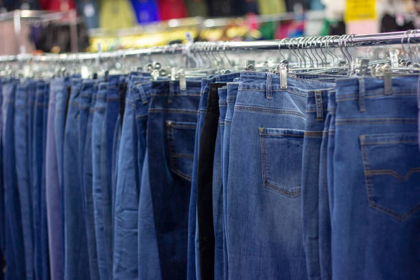 istock Many different blue Jeans on a hanging rack in the clothes shop store 1172422769