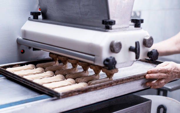 istock Automatic line for the production of eclairs. Eclair Cake Dough Baking, preparation 1172422791