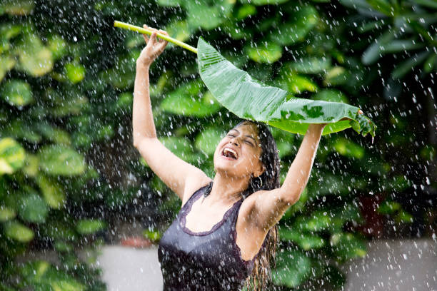 istock Woman enjoying rain 1172424445