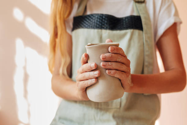 istock Hands of unrecognizable woman holding an unfinished mug 1172424785