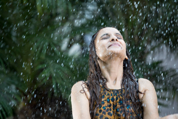 Indian woman enjoying rain