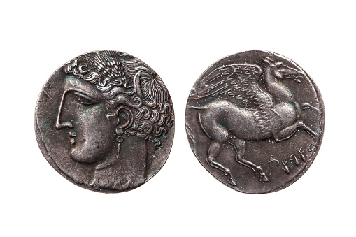 Silver 5 shekel Carthaginian coin replica with portrait of Tanit the sky goddess and the winged horse Pegasus on the reverse from the First Punic War 264-260 BC cut out isolated on a white background