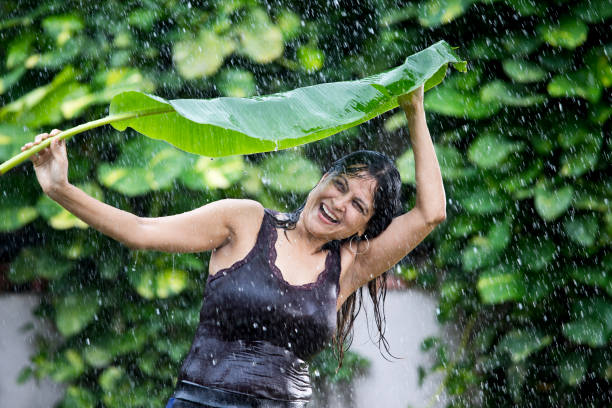 istock Woman enjoying rain 1172426616