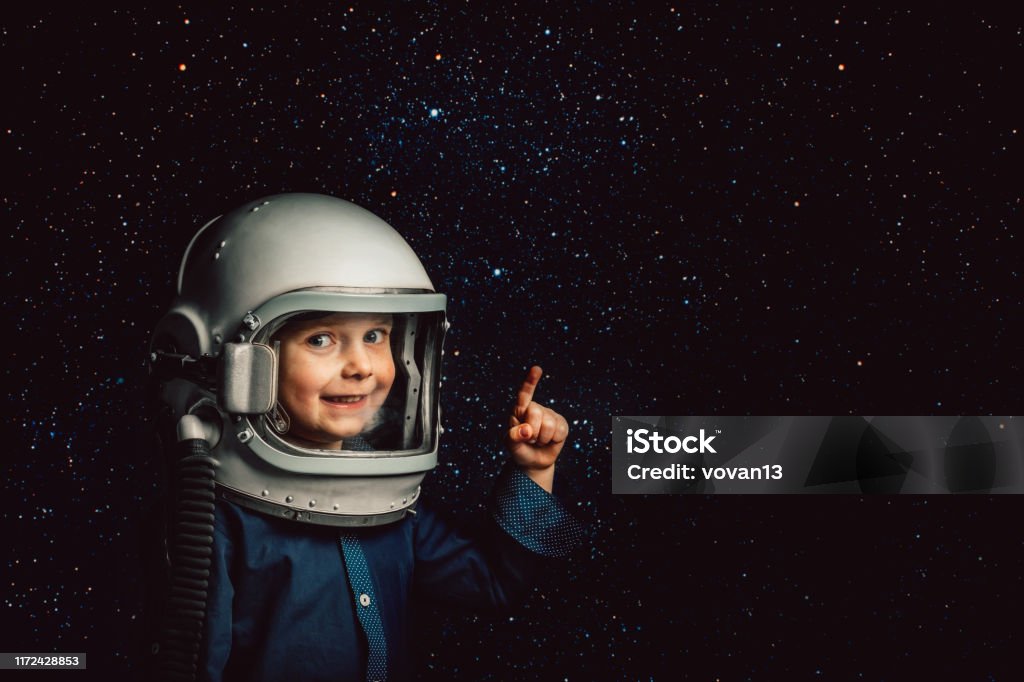 Small child wants to fly an airplane wearing an airplane helmet Child Stock Photo