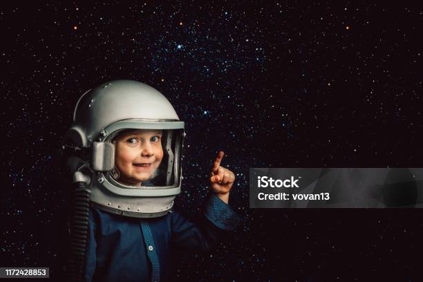 Small Child Wants To Fly An Airplane Wearing An Airplane Helmet Stock Photo - Download Image Now