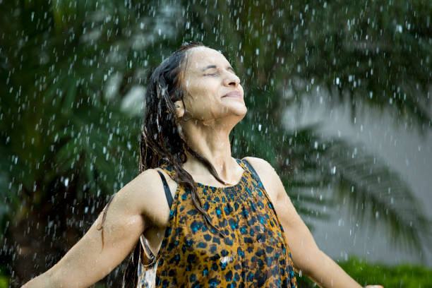 istock Indian woman enjoying rain 1172429815
