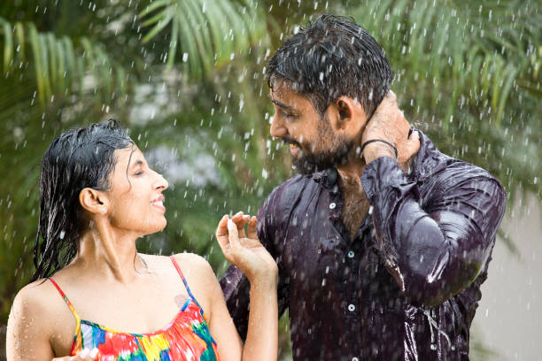 istock Romantic couple enjoying the rain 1172429840