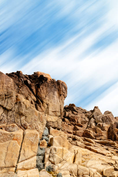 rock formation against sky in sillon de talbert area - long exposure rock cloud sky photos et images de collection