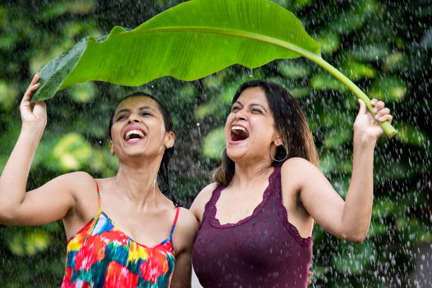 istock Tho women enjoying rain 1172431392