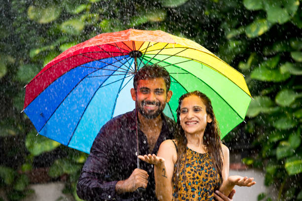Happy couple enjoying the rain Loving Indian couple enjoying in the rain monsoon stock pictures, royalty-free photos & images