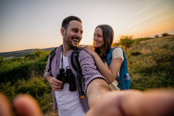 istock Happy couple taking selfie in sunset 1172432285