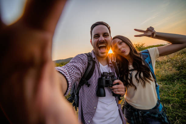 istock Happy couple taking selfie in sunset 1172432813