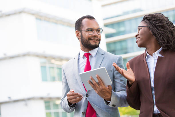 istock Multiethnic business team with tablet discussing ideas 1172433800