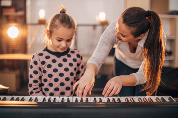 istock Young girl with her teacher on piano class 1172433894