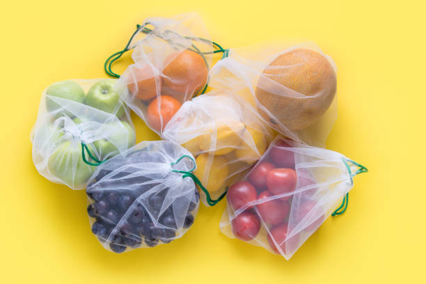 istock Fruits in reusable eco-friendly mesh bags on yellow. Zero waste. Ecological concept. Stop pollution. 1172436342