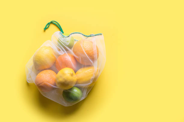 istock Fruits in reusable eco-friendly mesh bags on yellow. Zero waste. Ecological concept. Stop pollution. 1172436352