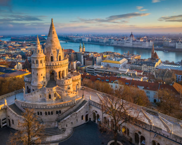 Budapest, Hungary - The main tower of the famous Fisherman's Bastion (Halaszbastya) from above Budapest, Hungary - The main tower of the famous Fisherman's Bastion (Halaszbastya) from above with Parliament building and River Danube at background on a sunny morning hungary photos stock pictures, royalty-free photos & images