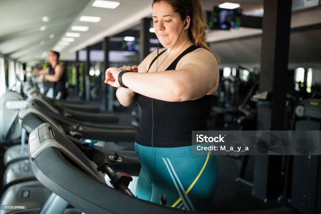 Overweight women at gym Motivated overweight women at gym Exercising Stock Photo