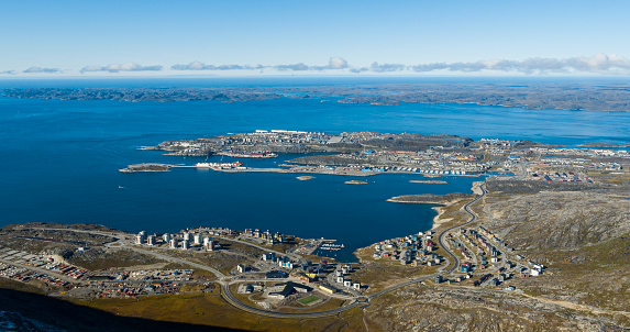 Greenlands capital Nuuk - largest city in Greenland aerial view. Drone image of Nuuk from air, aka Godthaab seen from Mountain Sermitsiaq aslso showing Nuup Kangerlua fjord.