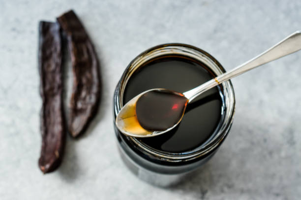 istock Carob Molasses Dripping from Spoon to Jar. 1172442007