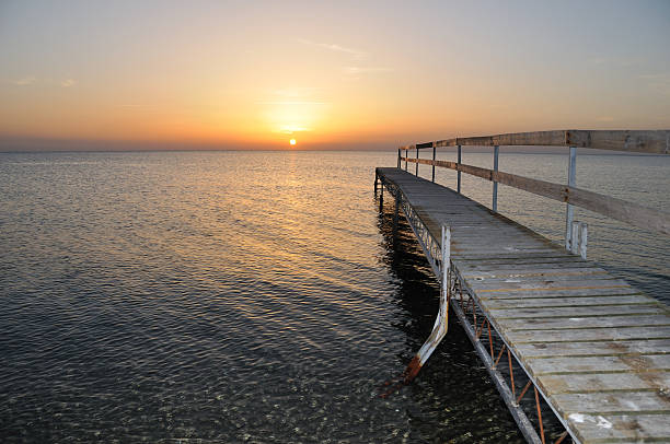 istock Sunset at the sea near a jetty 117244453