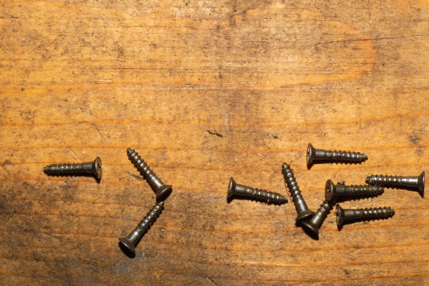 istock Screws on a wooden background. working tools 1172445873