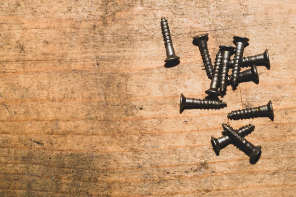 istock Screws on a wooden background. working tools 1172446226