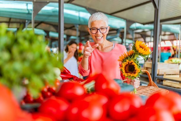 istock Senior woman choosing vegetables on a market. 1172447367