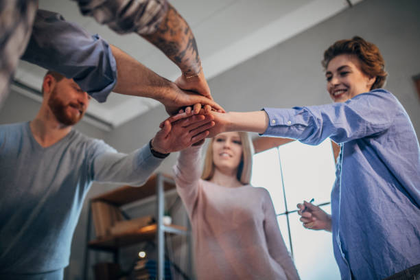 istock Office team holding hands together 1172447760