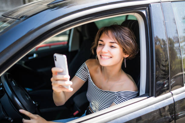istock Young woman using cellphone to take photo inside a car 1172448296