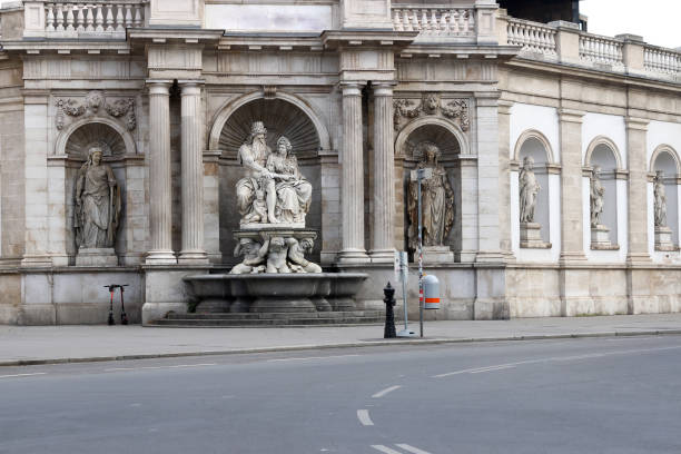 Neptune fountain on Albertinaplatz square at sunrise, Vienna, Austria