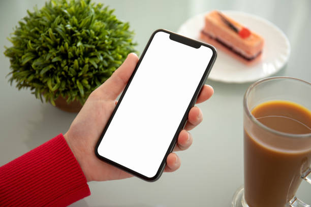 istock female hand holding phone with isolated screen in a cafe 1172450330