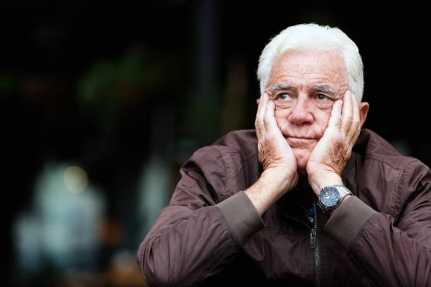 istock Frowning, unhappy old man his head in his hands 1172453518