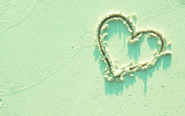 istock Heart and sand in mint color. 1172453544
