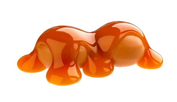 istock Caramel candies and caramel sauce isolated on white background 1172454139