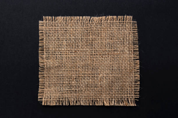 istock Old burlap fabric napkin on black background, top view 1172454322