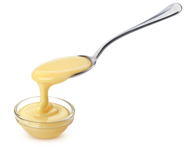 istock Pouring condensed milk isolated on white background 1172454392