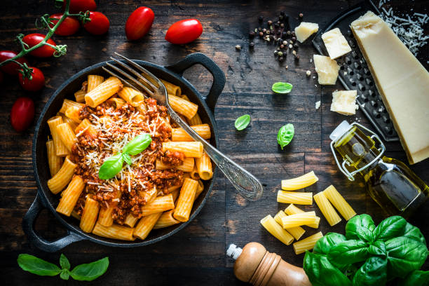 istock Rigatoni pasta with Bolognese sauce shot on rustic wooden table 1172455662