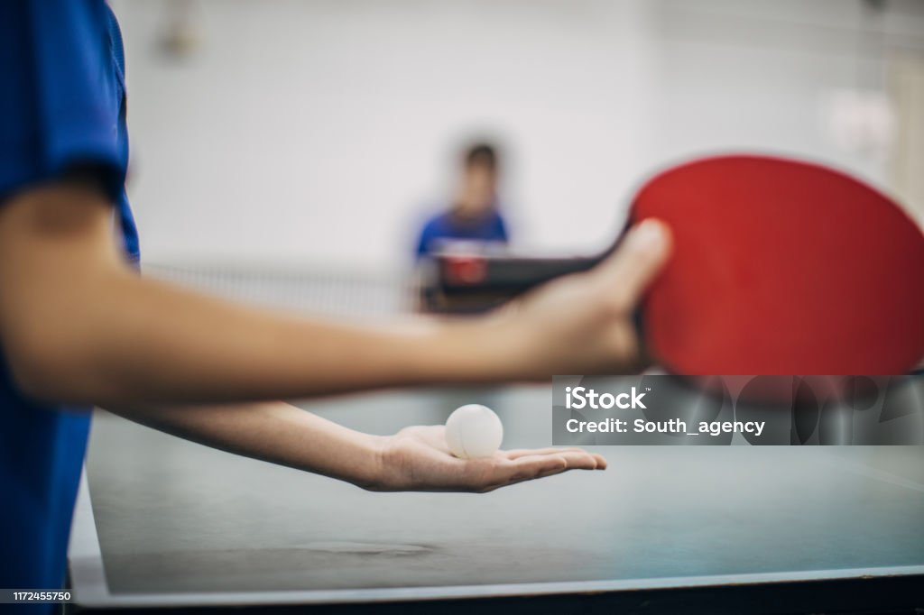 Let's play table tennis One woman, holding table tennis racket, ready to serve, part of. Table Tennis Stock Photo