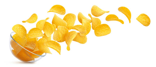 istock Potato chips falling into glass bowl isolated on white background 1172456243