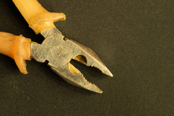 istock Pliers with orange handles on black background. copy space 1172463935