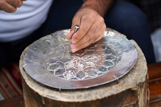 istock Handmade work with metal engraving. Craftsman working outdoors 1172464180
