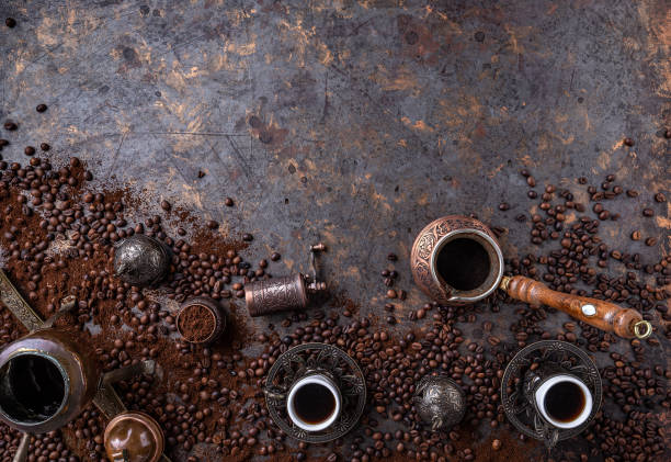 Copper coffee pot Copper coffee pot, vintage coffee grinder, cups and coffee beans on a dark vintage background turkish coffee pot cezve stock pictures, royalty-free photos & images