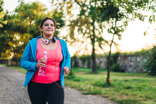 istock Young overweight woman running 1172467040