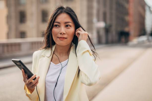 istock Cute Chinese woman using phone on the street 1172467199