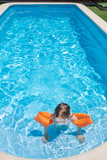 istock overhead view of child with armbands in pool 1172468482