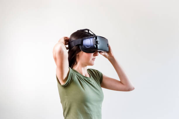 istock Brunette woman exploring modern technology virtual reality with head mounted display on white background 1172471363