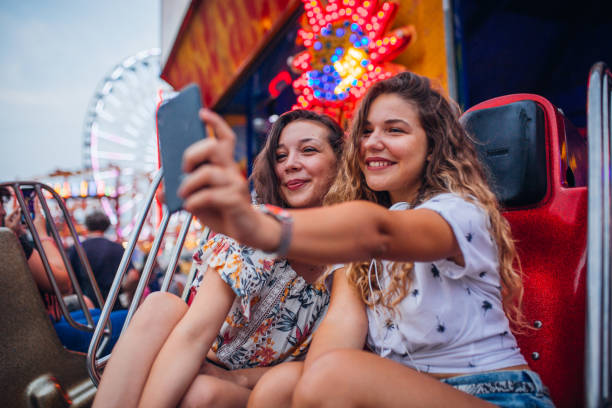 istock Girlfriends have fun at the amusement park 1172475558