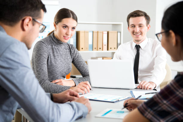 istock Businesswoman explains to colleagues a new project 1172478689