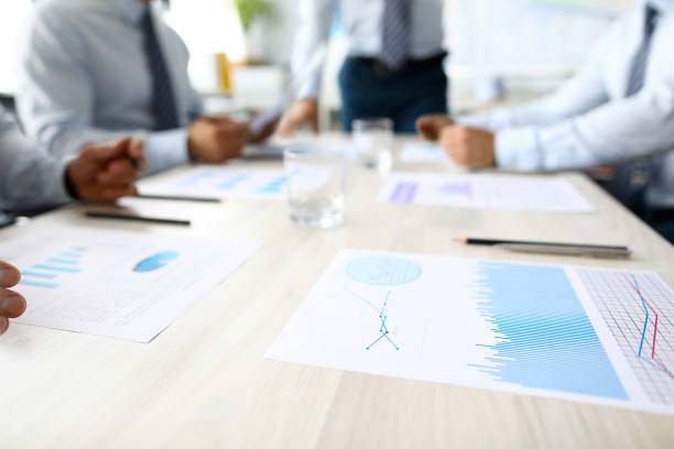 istock Business chart lie on table against group people 1172487103